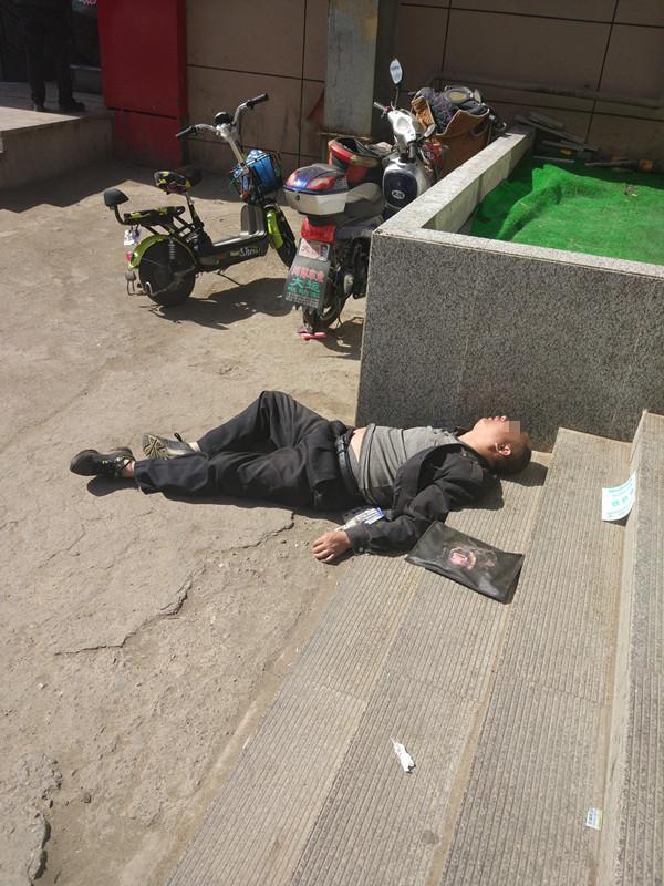 这酒估计真是没少喝 一名中年男子醉卧红旗街商圈街头